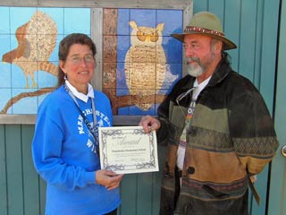 Randy Sinclair presents FoGR's first 'Eco-Hero' award to Cindy Gonzales, principal of Manchester School