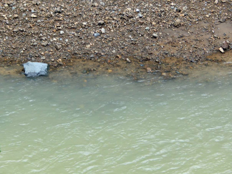 River turbidity downstream of landslide; olive gray-green hue; visibility to depth of at least 6 inches. Note visible cobbles shallowly submerged below the bank. March 3, 2019.