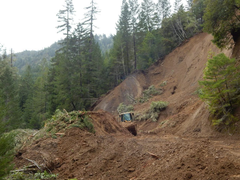 Landslide at Stewarts Point-Skaggs Springs Road west of Soda Springs site (USGS map place-name). Partial removal of landslide at and above the buried road surface. March 3, 2019.
