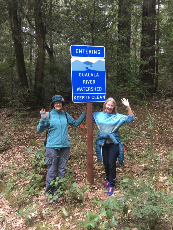 Newly installed sign welcoming people to the Gualala River watershed, with volunteers Lynn Walton (right) and Mary Sue Ittner (left); photo by Harmony Susalla