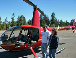 Gabrielle and Ken Adelman with their Robinson R44 helicopter